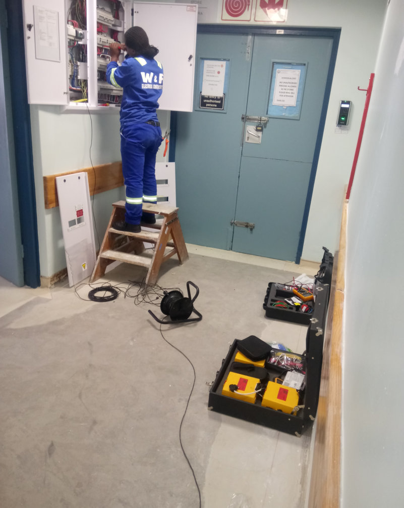 W&F electrician installing electrical panel